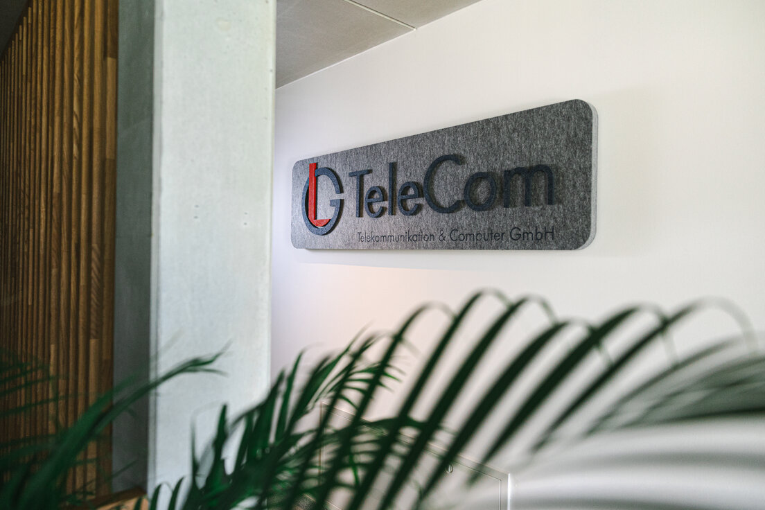 © © www.Lindner-Group.com Grauer MUTE+® board Schallabsorber mit aufgedrucktem LG TeleCom Logo an der Wand – individuelle Akustiklösung von Lindner für markenstarke Raumgestaltung. | © © www.Lindner-Group.com